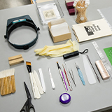 Toolsfor conservation treatments laid out on a gray table