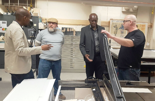 The Falls discuss conservation and preservation techniques with Hoover Rayan Ghazal, Hoover preservation officer, and library specialist James Fayne