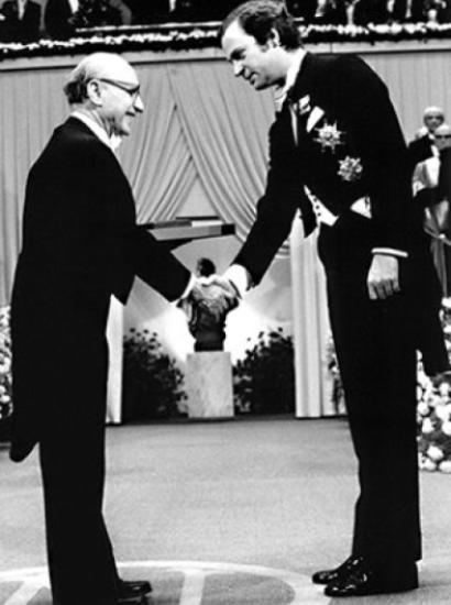 Milton Friedman receives the 1976 Bank of Sweden Prize in Economic Sciences in Memory of Alfred Nobel from King Carl XVI Gustaf of Sweden.