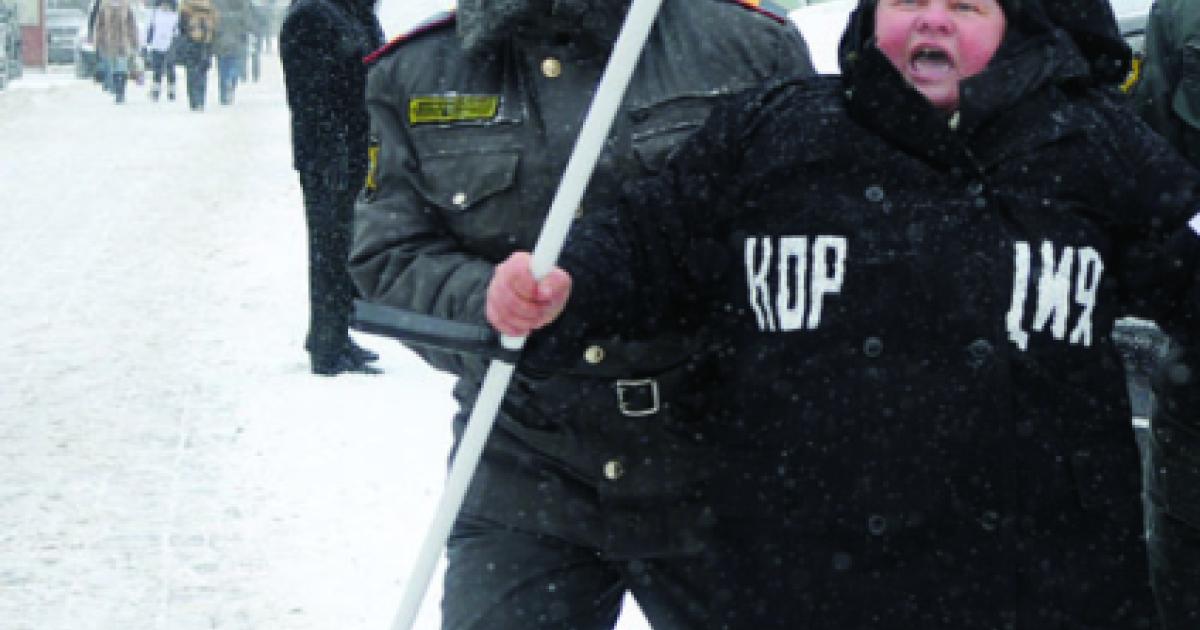 Moscow police officer detains a demonstrator