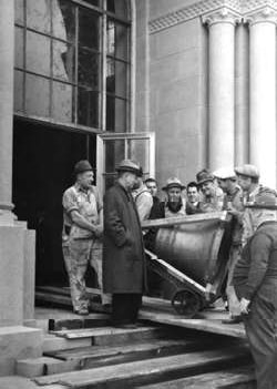 Hoover Library director Ralph Lutz (second from left) watches workmen bring the bells into Hoover Tower, 1941. Hoover Institution Archives.