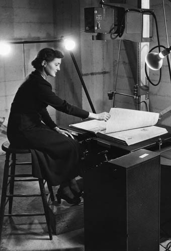 Kathleen Fitzke works at the World War I newspaper microfilming project in the Hoover Tower in 1951.