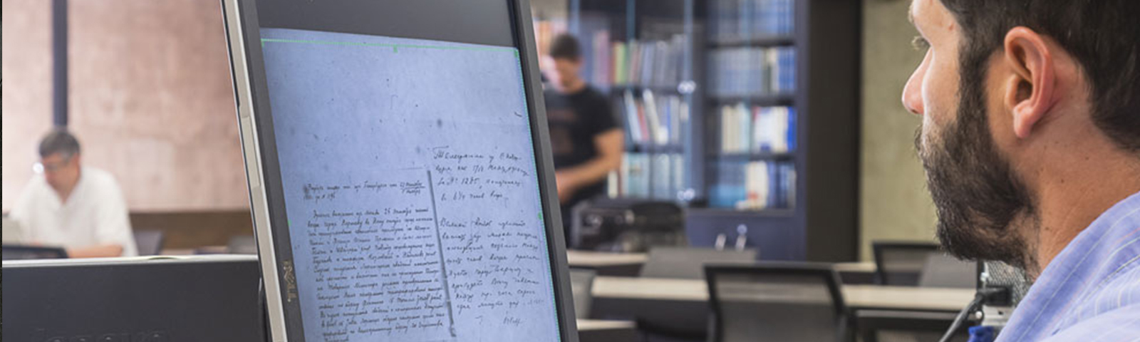 detail of photo showing a researcher using the IMF records