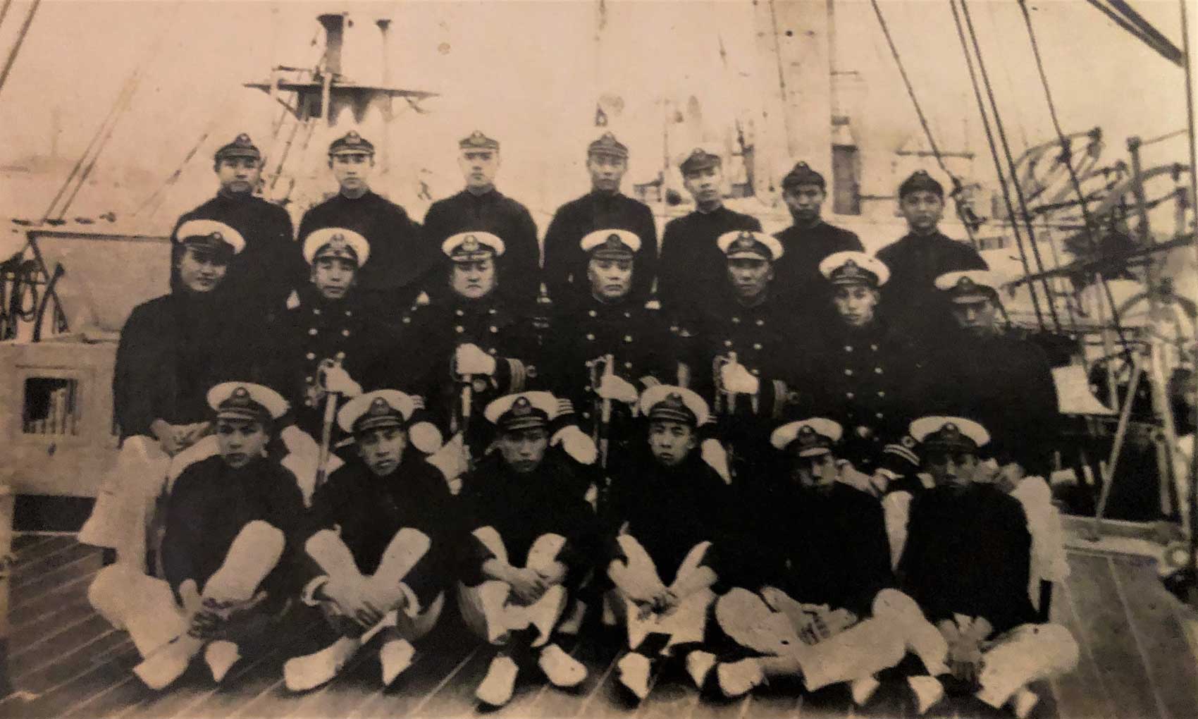 Sepia colored photograph of Kao with cadets posing on the deck of a boat