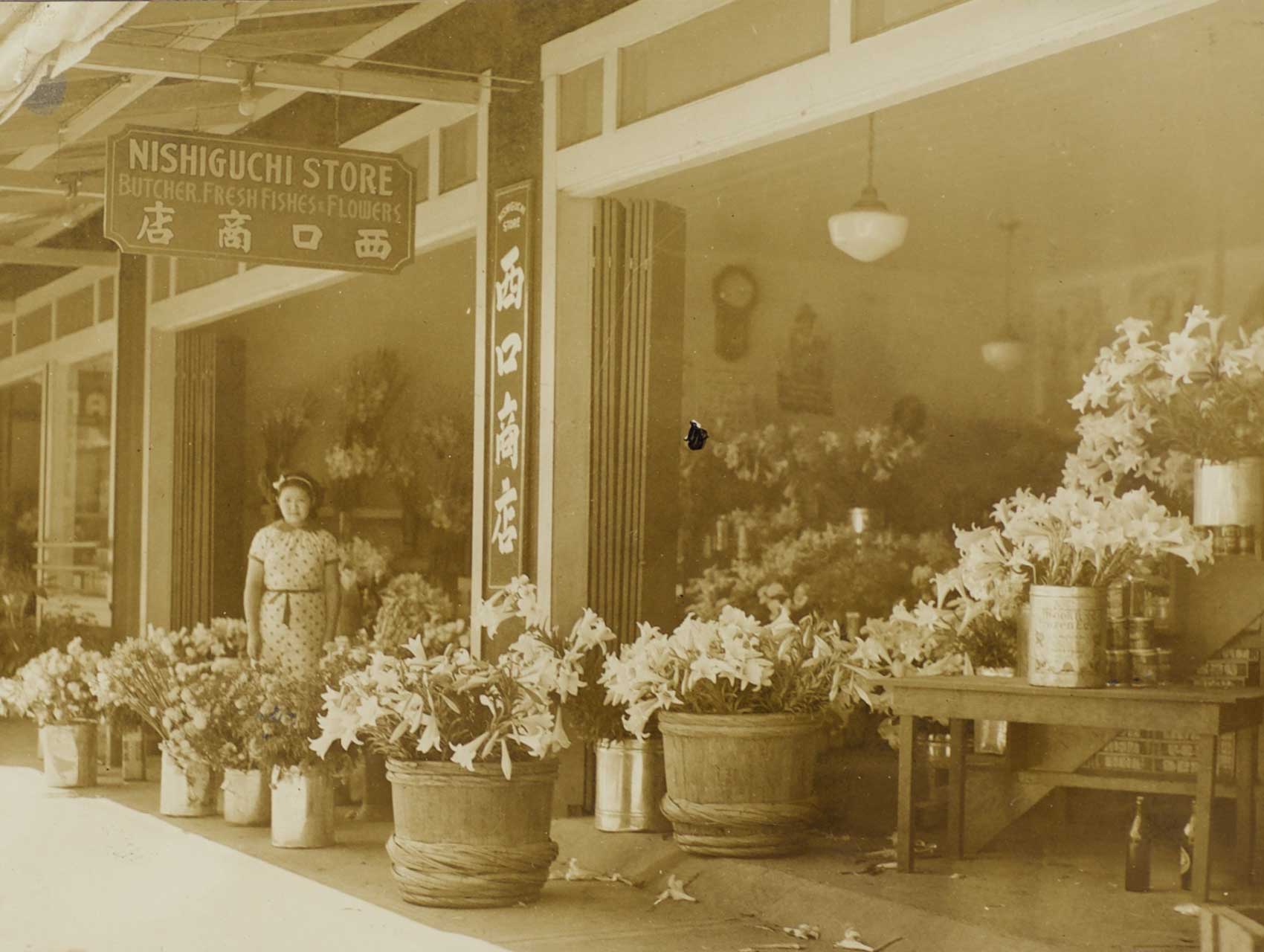 Nishiguchi Storefront woman standing amongst flowers