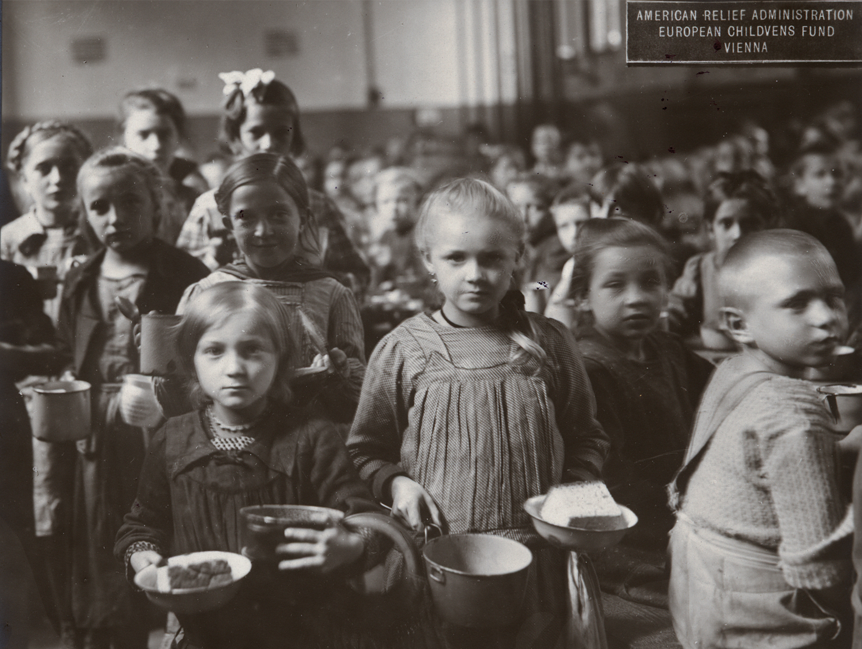 Black and white photograph of children receiving food at an American Relief Administration kitchen in Vienna
