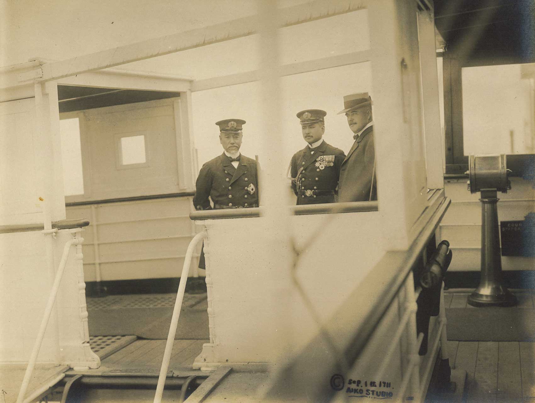 3 men standing on the deck of the Tanba Maru