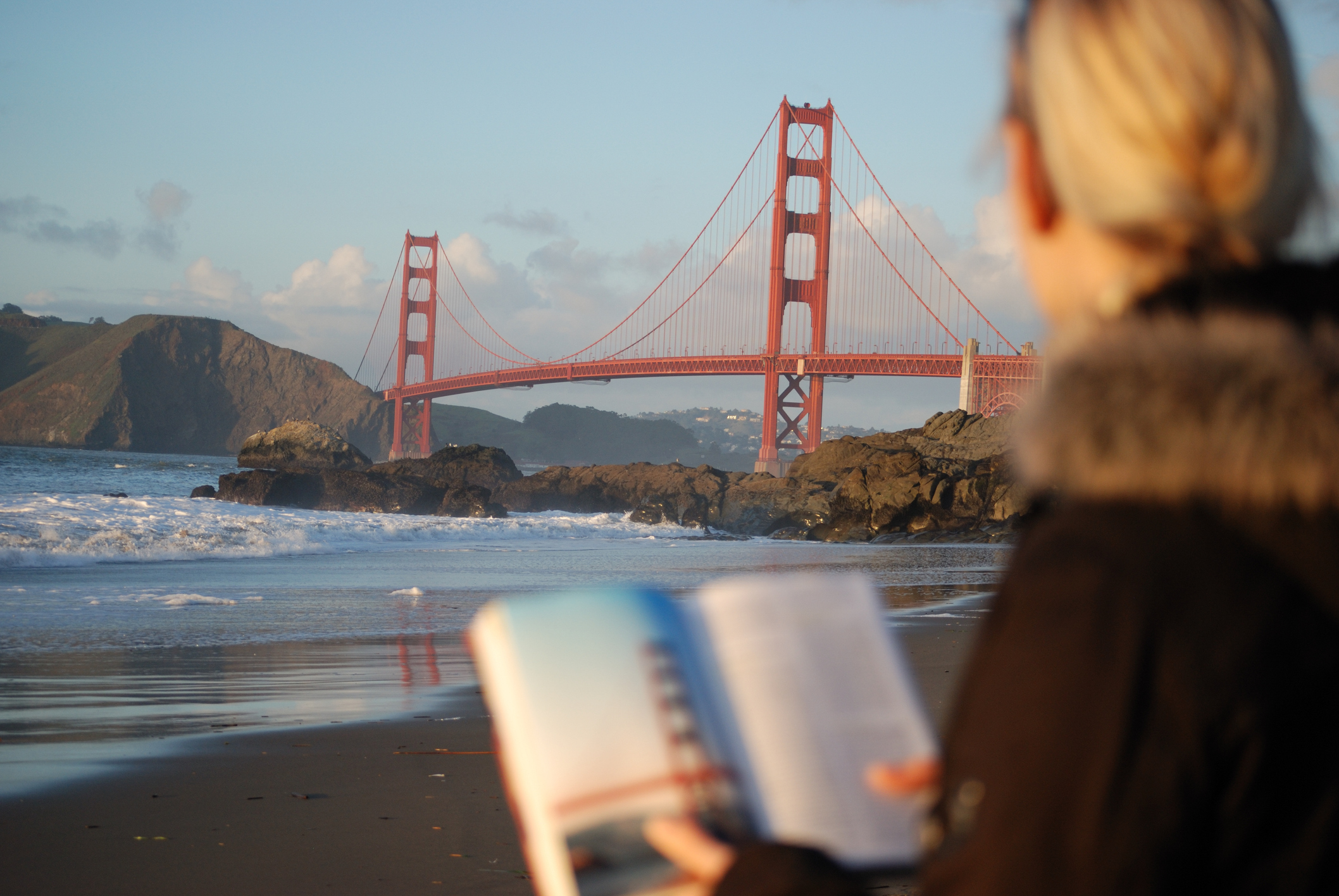 Californian reading a book near the Golden Gate Bridge