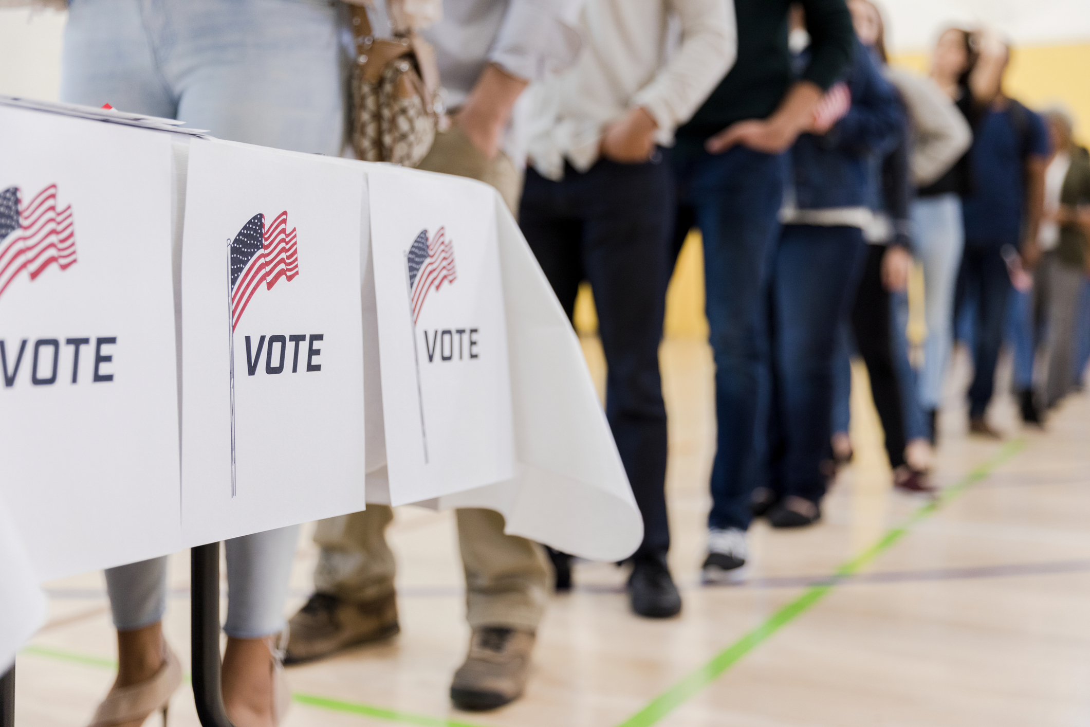 Low angle view of people lined up to vote stock photo
