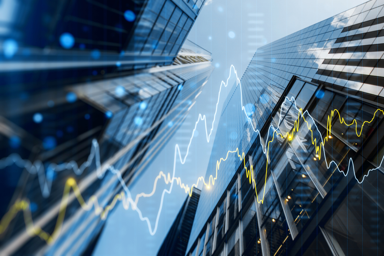 A double exposure image of skyscrapers with overlay of financial graphs, set against a blurred background, illustrating the concept of business growth stock photo