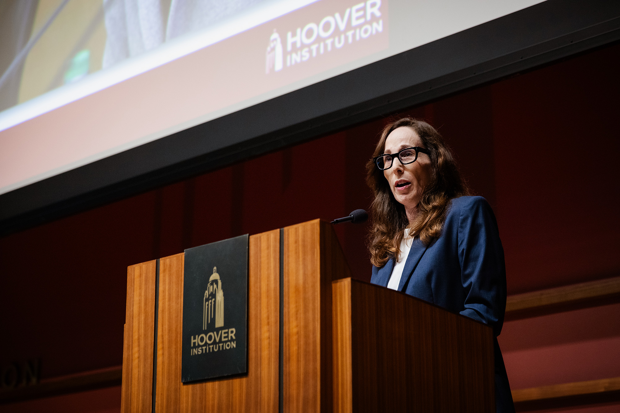 Senior Fellow Amy Zegart speaks to Hoover Institution supporters in Hauck Auditorium on July 9, 2025. (Patrick Beaudouin)