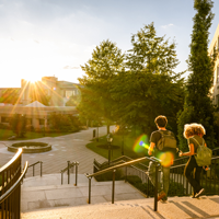 Two university students walk down campus stairs stock photo