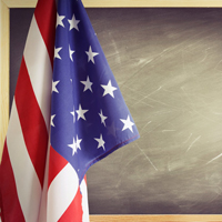 American flag in front of a blackboard