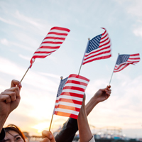 People waving US flags for holidays celebration stock photo