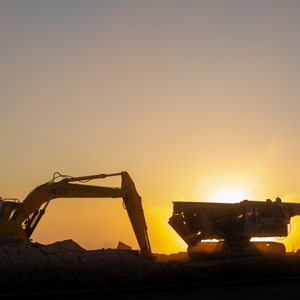 Construction machinery in the rays of the rising sun, early morning at the construction site stock photo