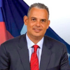 Prime Minister Alix Didier Fils-Aimé is a businessman and economist educated at Boston University, who built his career in private enterprise and previously served as president of the Chamber of Commerce and Industry of Haiti. In November 2024, he was selected as acting prime minister by Haiti's Transitional Presidential Council, and when that body's mandate expired in February 2026, he became Haiti's de facto executive, focused on defeating gang coalitions and restoring democratic governance.