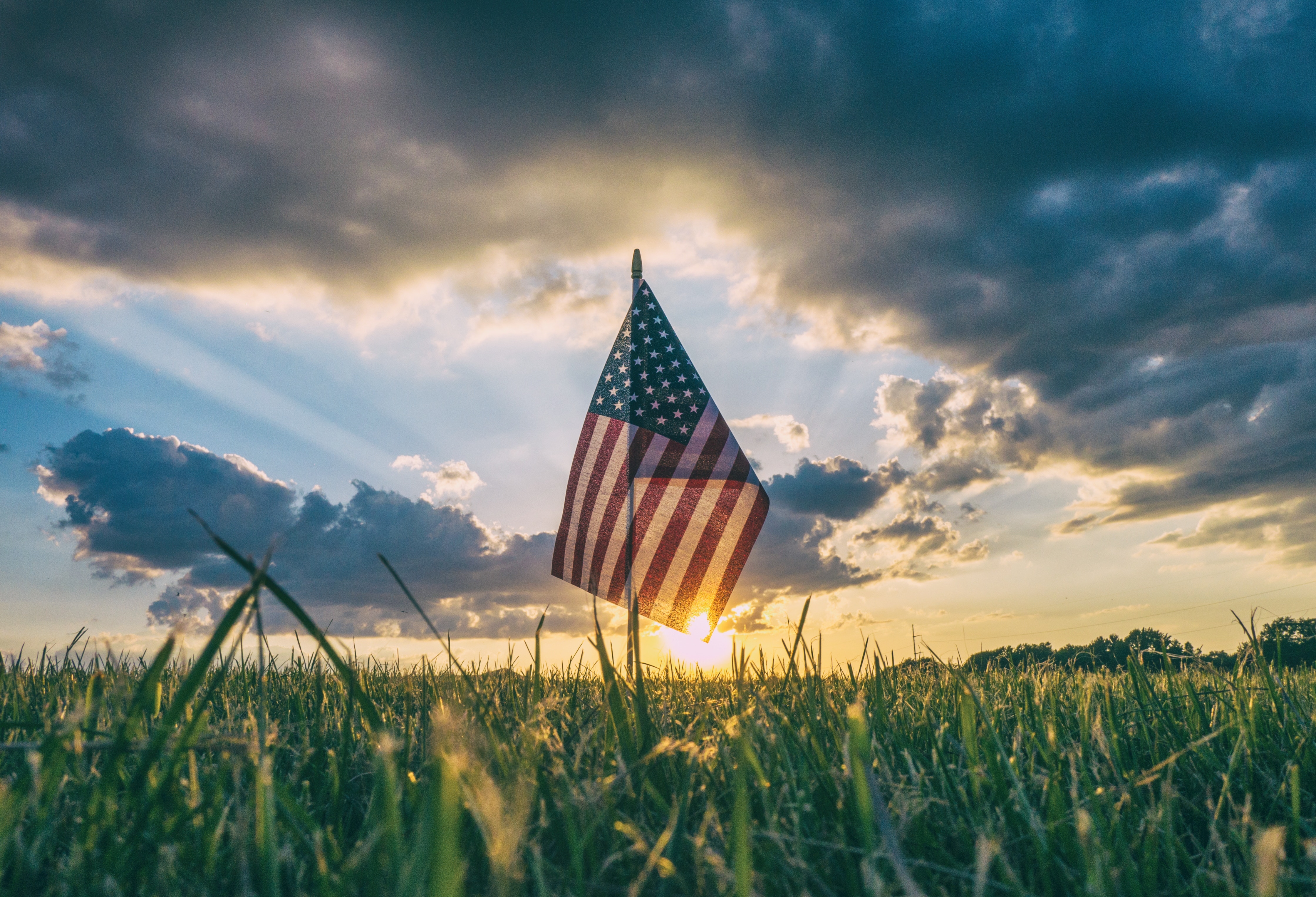 American Flag flying over a field