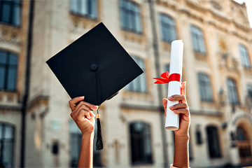 Cropped image of graduate holding academic hat and diploma with red ribbon. Happy graduation, bright future, success and confidence. stock photo
