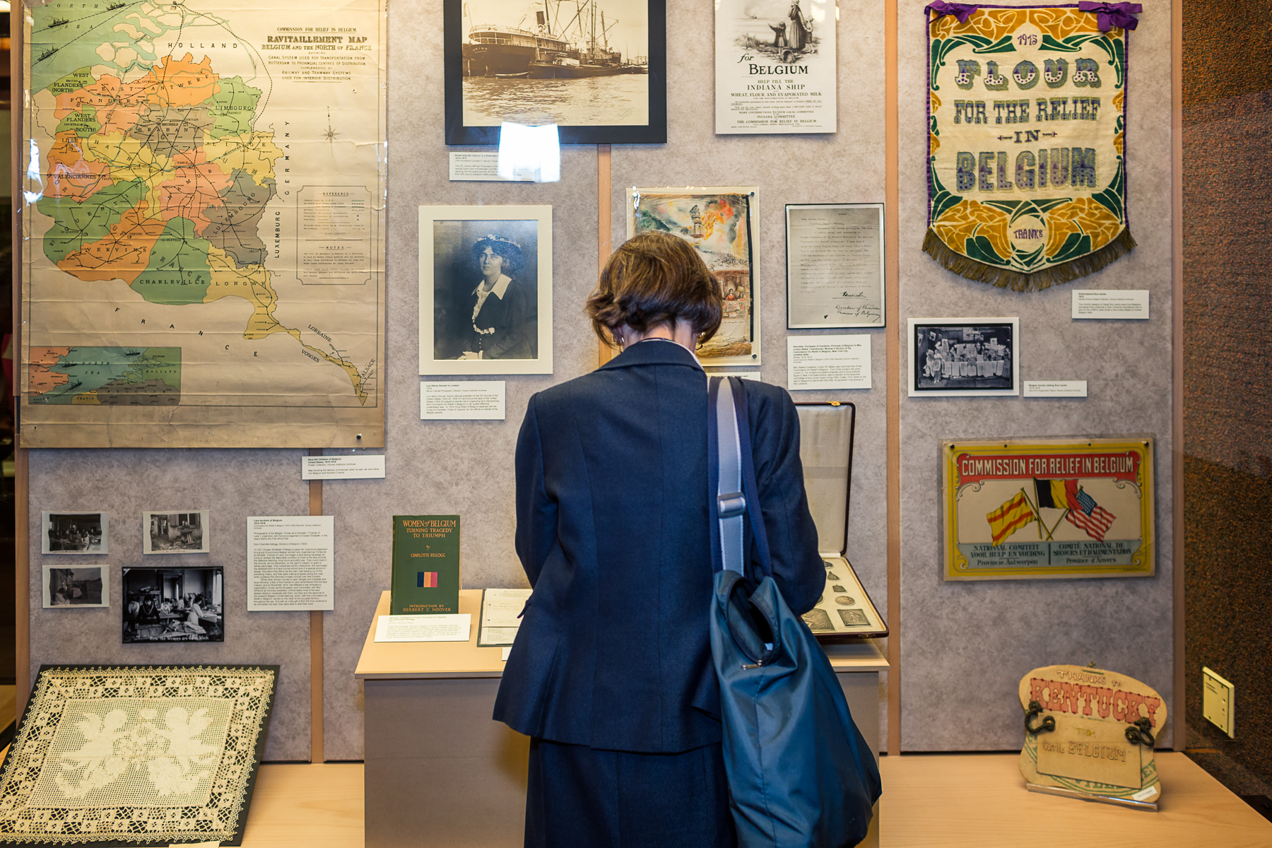 Color photograph of a woman looking at a Hoover exhibition