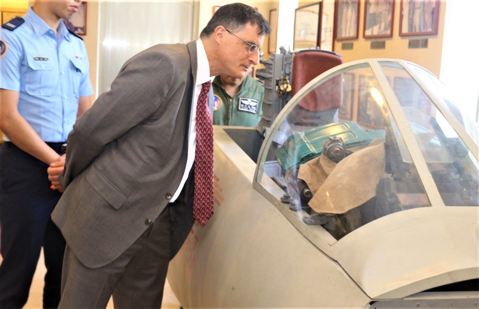 Eric Wakin looking into the cockpit of a plane on display at the American Footprint Museum