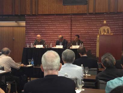 3 panelist sitting at a table in front of a group of people at a workshop