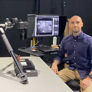 Spencer Zidarich sitting by the high-resolution camera system 