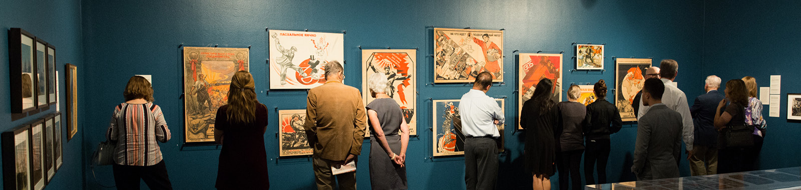 Visitors in exhibit gallery looking at Russian Revolution posters