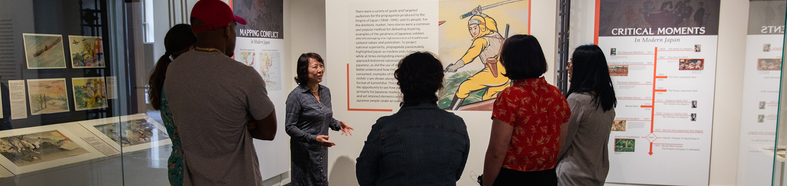 Curator speaking to a group of people in exhibit gallery