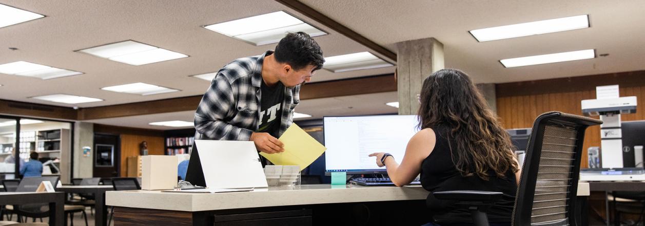 Researcher and reference archivist in reading room 