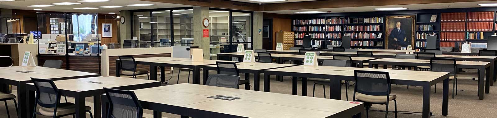 reading room with tables chairs bookshelves in the background