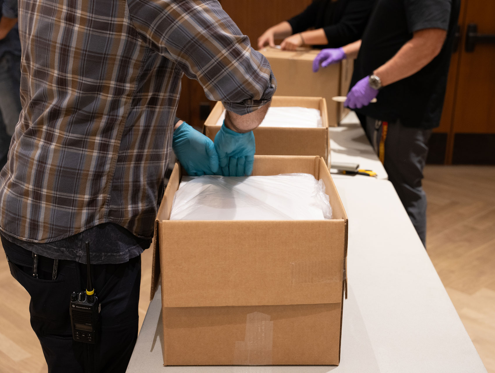 L&A staff packaging materials in a box