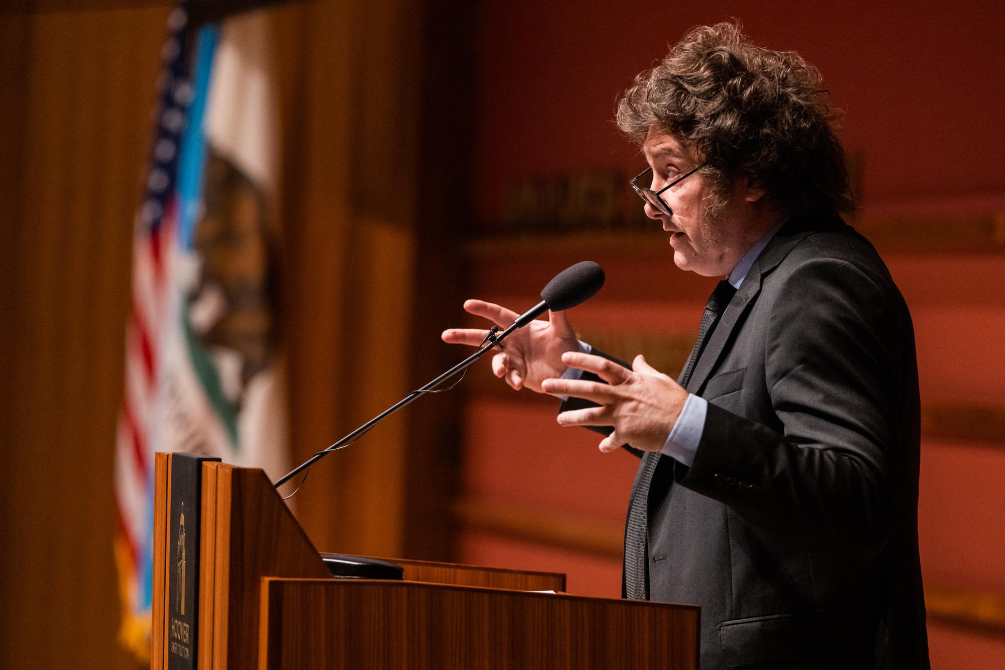 Argentine President Javier Milei gestures at the podium as he speaks in Hauck Auditorium