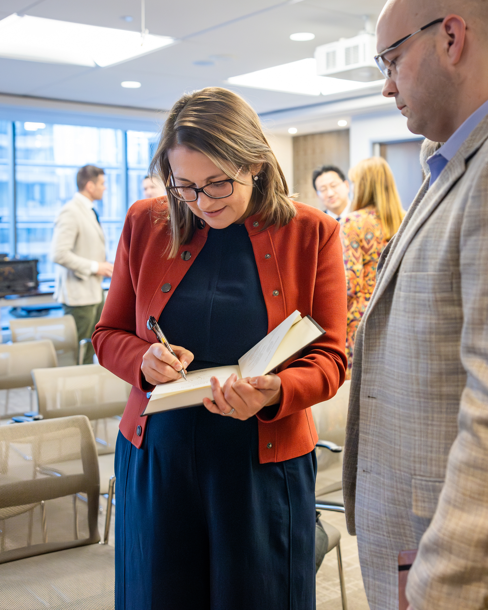 Julia Mcdonald, a professor at the Korbel School of International Affairs, signs a copy of The Hand Behind Unmanned, during a book launch event at Hoover’s Washington, DC office on March 26, 2025.