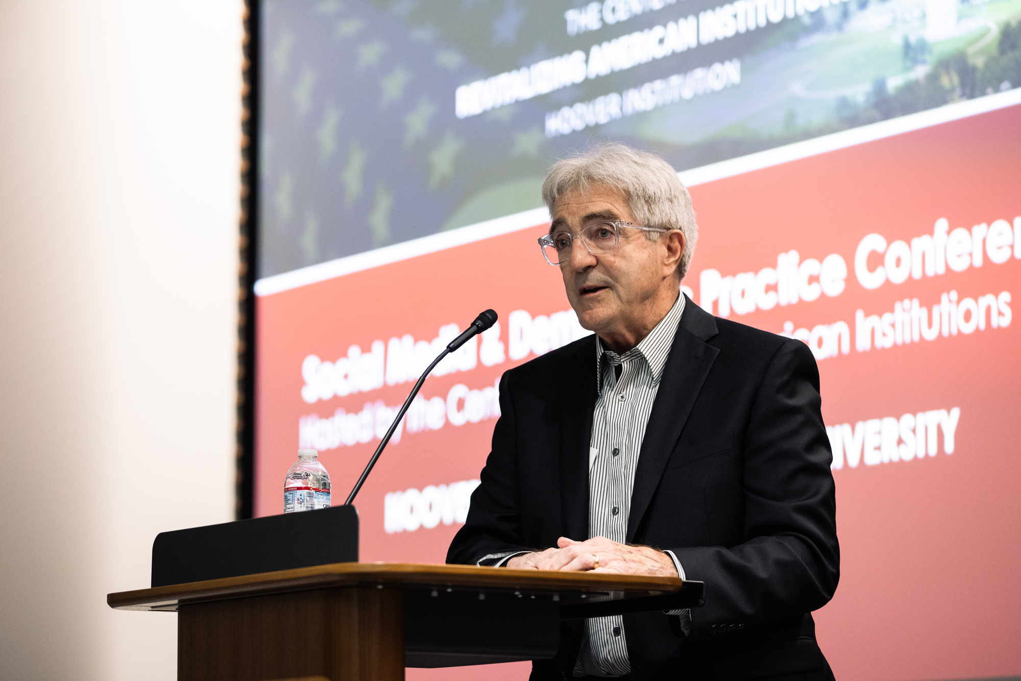 Senior Fellow Morris P. Fiorina speaks to attendees of the Social Media and Democratic Practice conference in Shultz Auditorium on March 17, 2025. (Patrick Beaudouin)