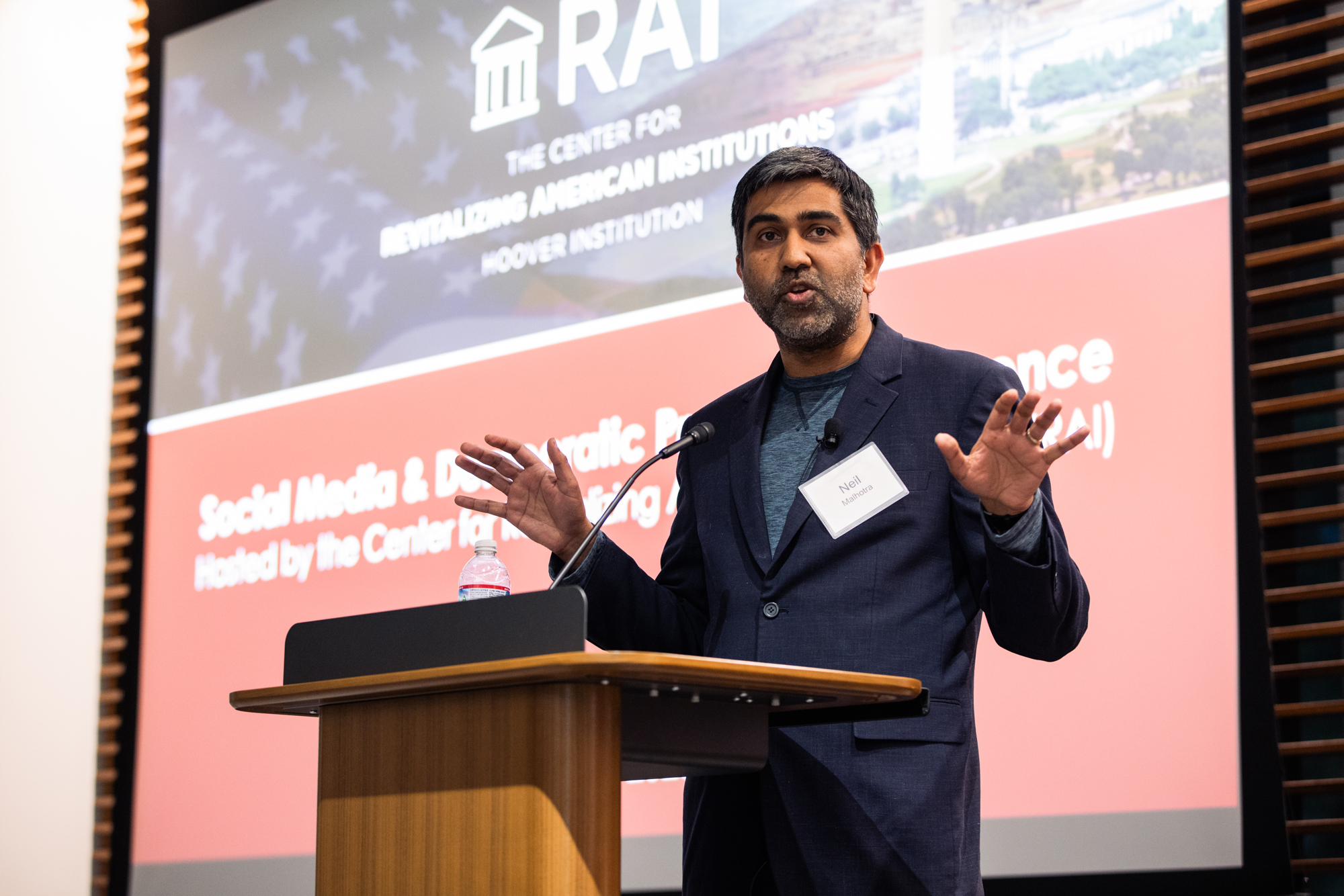 Stanford political economist Neil Malhotra speaks at the Social Media and Democratic Practice conference in Shultz Auditorium on March 17, 2025. (Patrick Beaudouin)