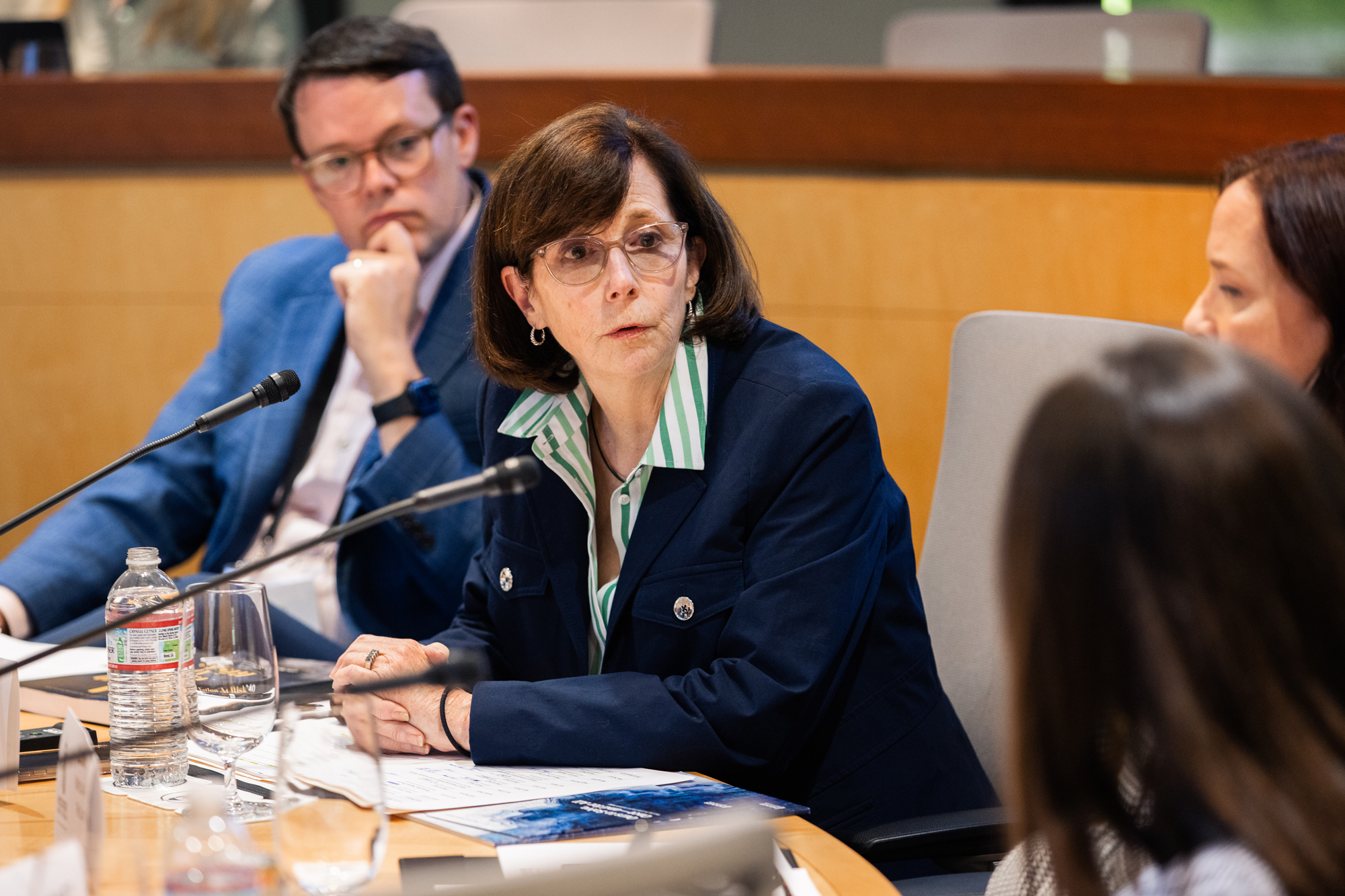 Distinguished Research Fellow Margaret (Macke) Raymond speaks with governor’s staff members on May 20, 2025. (Patrick Beaudouin)