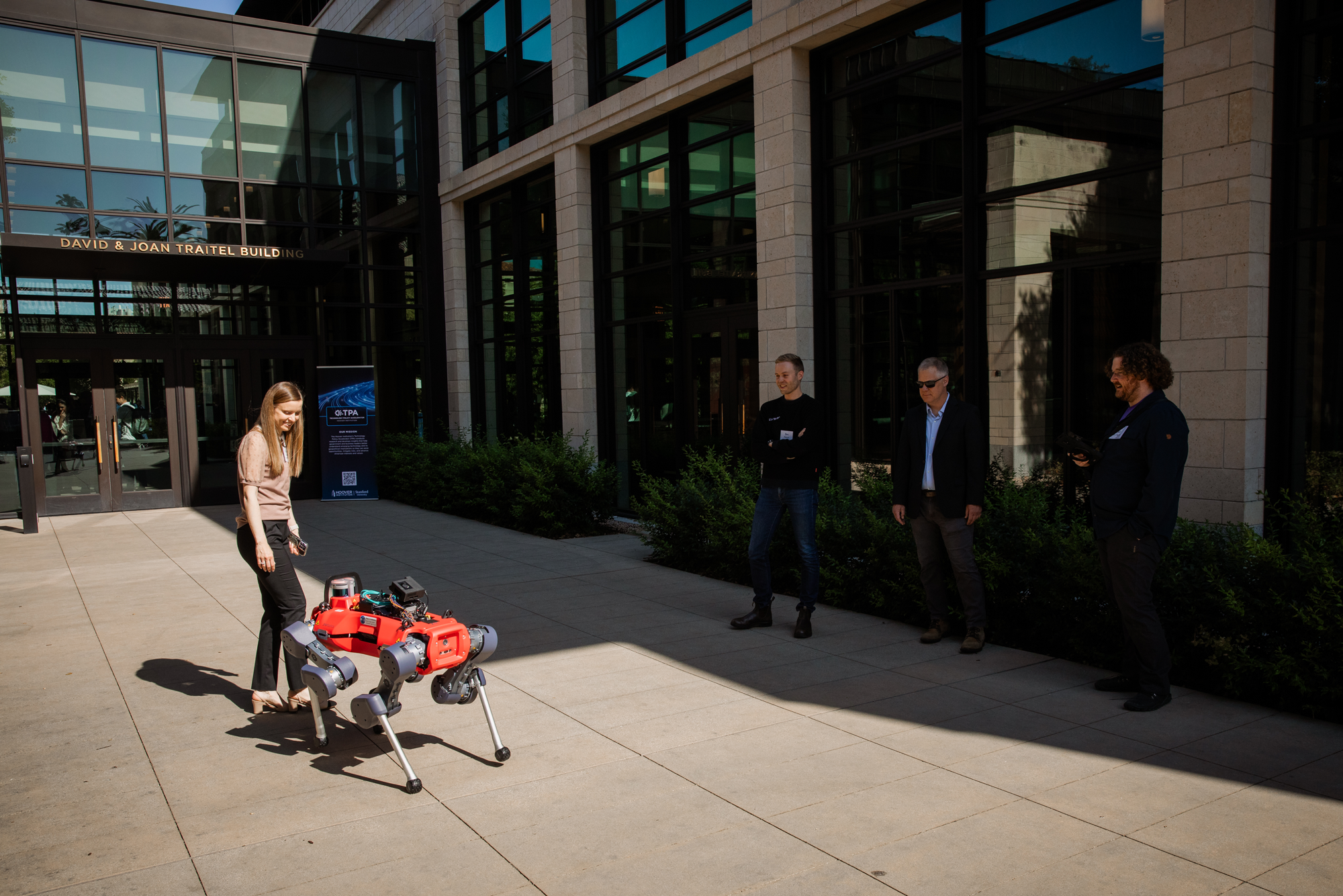 A four-legged robot walks outside the Hoover Institution’s David & Joan Traitel Building at a launch event for the new Technology Policy Accelerator on June 16, 2025. (Patrick Beaudouin)