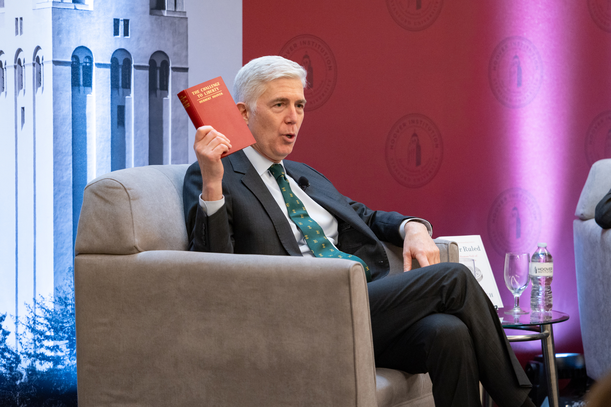 US Supreme Court Justice Neil Gorsuch holds up a copy of Herbert Hoover’s The Challenge to Liberty while speaking at the Hoover Institution’s Winter Board of Overseers meeting on February 24, 2025. 