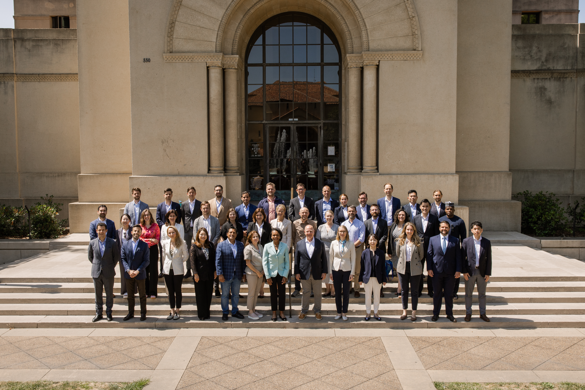 The 2025 cohort of Hoover Institution International Seminar participants are seen outside Hoover Tower with Condoleezza Rice and H.R. McMaster (center) on June 23, 2025. (Patrick Beaudouin)