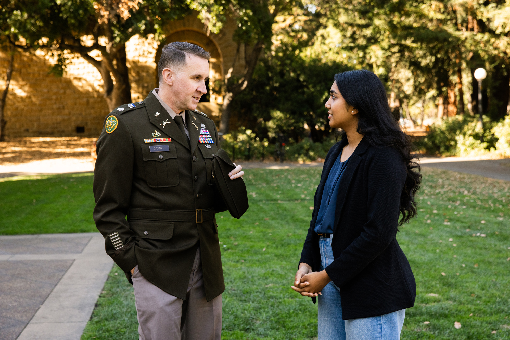 National Security Affairs Fellow Lt. Col. Thomas N. Garner and his mentee Anika Yadav (28’) speak outside Hoover Tower on Stanford campus on Nov. 8, 2024. (Patrick Beaudouin)