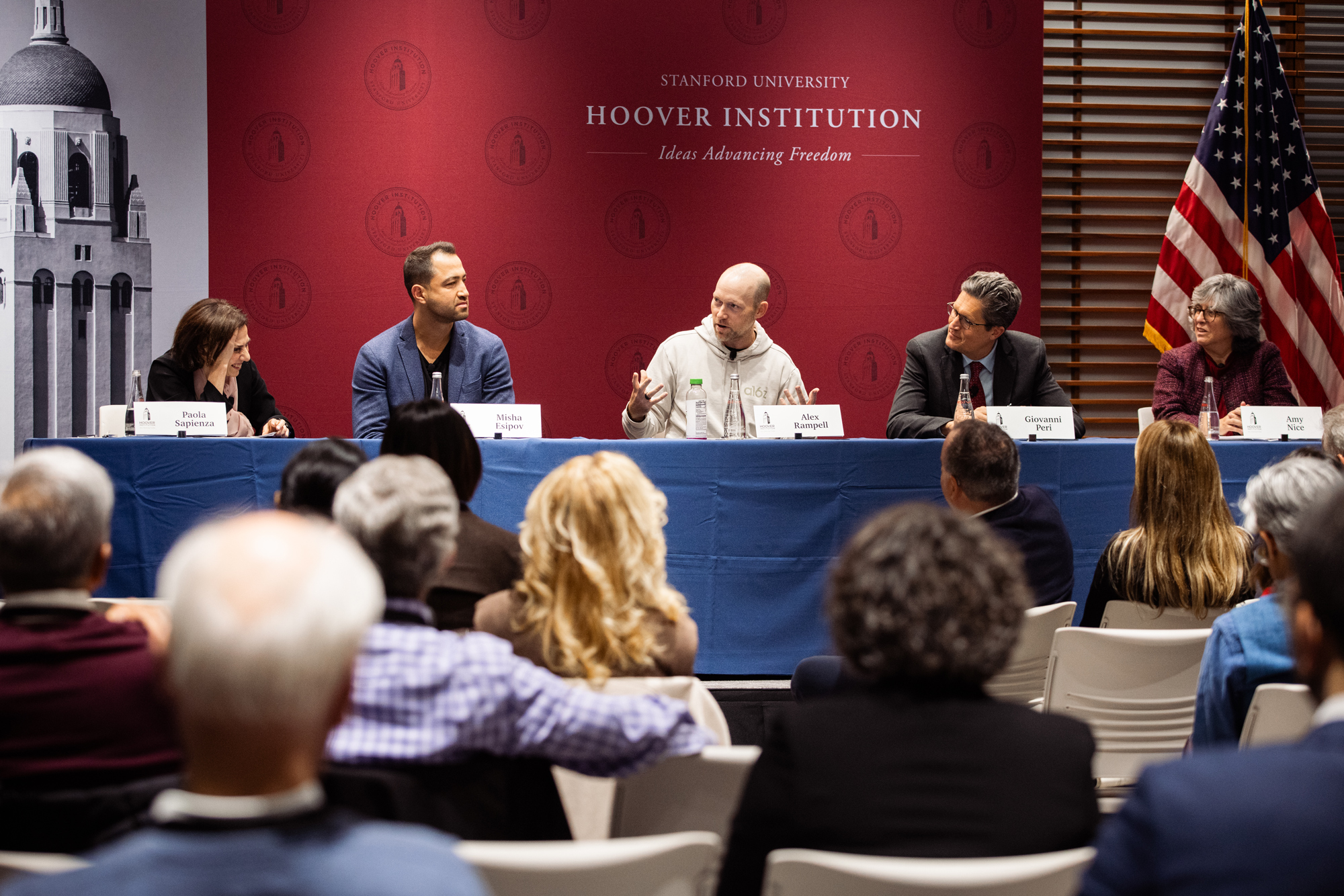 From left to right: Paola Sapienza; Misha Esipov, cofounder and CEO of Nova Credit; Alex Rampell, general partner at Andreessen Horowitz; Giovanni Peri, professor of economics at UC Davis; and Amy Nice, distinguished immigration counsel at the Institute for Progress, serve on a panel. (Patrick Beaudouin)