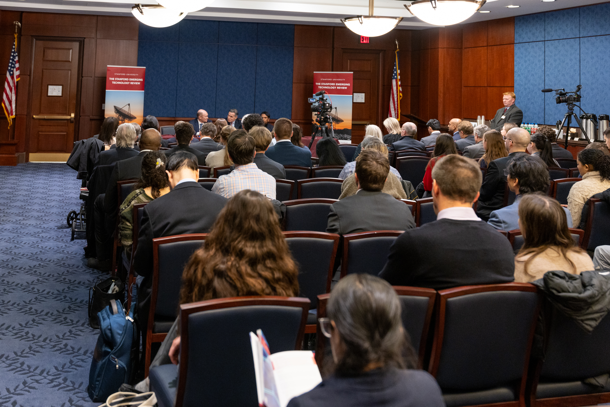 Audience members listen to Director Rice and Senators Coons and McCormick discuss the SETR report.