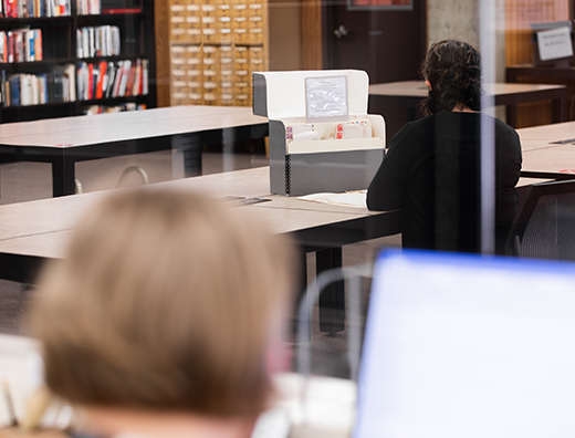 Color photograph of researcher working in the Hoover reading room