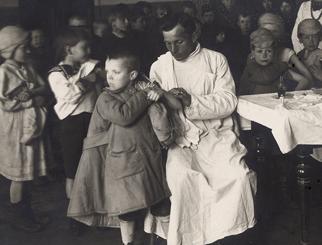 black and white photograph showing the vaccination of a young boy in Russia, 1922