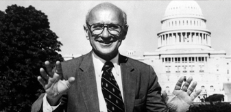 detail of a black and white photo of exonomist Milton Friedman with the US Capitol building in the background
