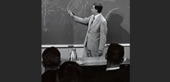 Detail of black and white photo of Edward Teller teaching in front of a blackboard