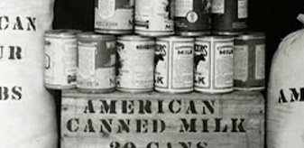 Detail of a black and white photo showing some goods provided in relief by the ARA in Russia, including American Canned Milk