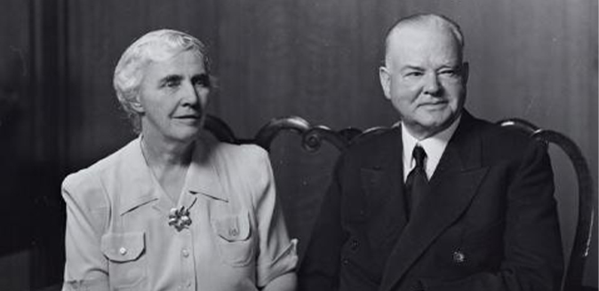 Black and white photograph of Mr. & Mrs. Herbert Hoover seated next to each other.