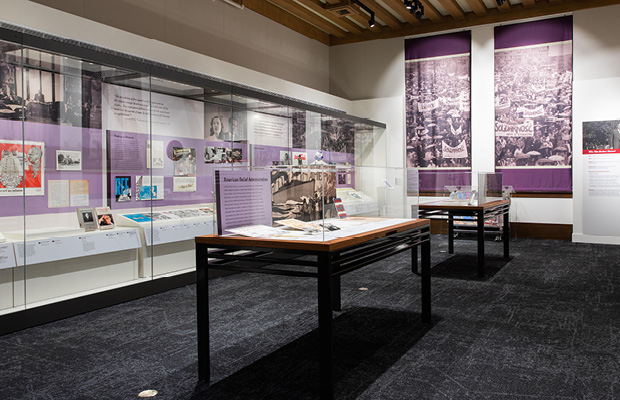 Exhibition gallery in Hoover Tower with objects on display in wall case and vitrines