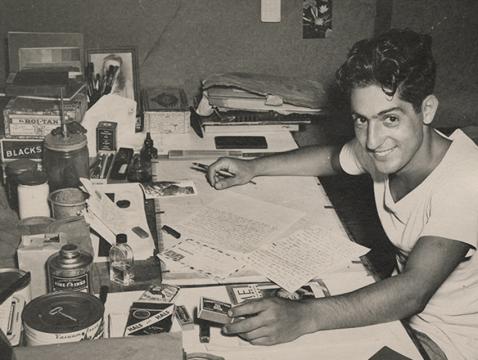 Nat Bellantoni photographed at his desk writing letters